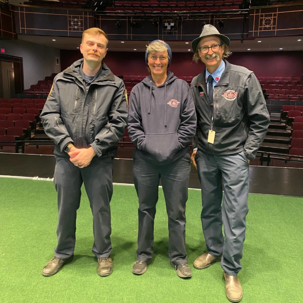 Image — Asheville Fire Department heroes on the Diana Wortham Theatre stage, left to right: Matt Sarachaga, Tracy Coggins, Weston Hall.